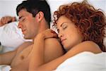 Close-Up of Couple Sleeping In Bed