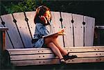 Girl Dressed as Businesswoman Sitting on Bench Using Cell Phone