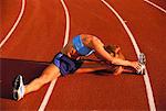 Woman Stretching on Running Track