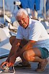 Portrait of Mature Man Tying Boat To Dock