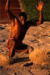 Man Long Jumping into Sand Pit