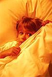 Boy in Bed, Covering Face with Sheets