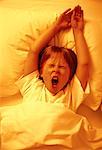 Boy Lying in Bed, Yawning