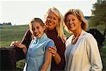 Portrait of Grandmother, Mother And Daughter Leaning on Fence