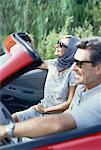 Mature Couple Driving Convertible