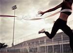 Woman Crossing Finish Line at Outdoor Track