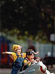 Two Children Playing with Toy Airplane Outdoors