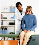 Male Physiotherapist Stretching Female Patient's Neck