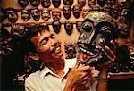 Man Holding Wooden Mask in Shop Bali, Indonesia