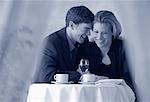 Couple Sitting at Table, Smiling