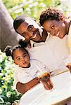 Portrait of Family Sitting at Table Outdoors