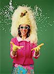 Portrait of Mature Woman Wearing Hat and Glasses Throwing Confetti