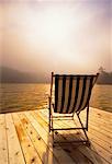 Deck Chair on Dock at Sunrise With Morning Mist Meech Lake, Quebec, Canada