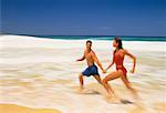 Couple in Swimwear, Running in Surf on Beach Dominican Republic, Caribbean