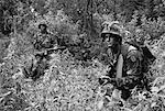 Soldiers Wearing Camouflage Carrying Weapons in Jungle