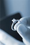 Close-Up of Hand Holding Diamond Ring