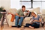 Couple Relaxing at Home with Take Out Food and Book