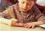 Boy Sitting at Desk, Writing