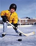 Portrait of Boy Playing Hockey At Outdoor Ice Rink