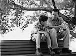 Father and Son Sitting on Park Bench