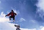 Snowboarder Jumping over Hill Jungfrau Region, Switzerland