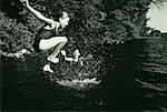 Girl in Swimwear, Jumping into Water, Belgrade Lakes, Maine, USA