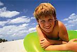 Portrait of Boy on Beach with Inner Tube, Miami Beach, Florida USA