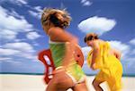 Blurred View of Boy and Girl in Swimwear, Running on Beach Miami Beach, Florida, USA