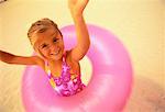 Portrait of Girl in Swimwear with Inner Tube on Beach Miami Beach, Florida, USA