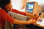 Teenage Girl Using Phone at Computer, Painting Toenails