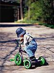 Boy with Tricycle on Driveway