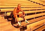 Portrait of Mature Man Sitting On Bleachers with Water Bottle