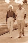 Mature Couple Walking on Path Holding Hands