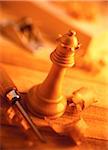 Close-Up of Wooden Chess Piece And Carving Tools