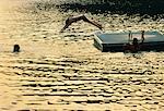 Three Girls Swimming near Floating Dock