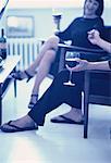 Mann und Frau sitzen auf Stühlen mit Gläser Wein, lachen