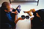 Overhead View of Man and Woman In Chairs Holding Glasses of Wine