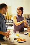 Couple Preparing Food in Kitchen