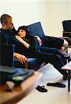 Couple Relaxing on Sofa with Glass of Wine on Table