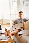 Portrait of Man Sitting on Sofa Holding Newspaper