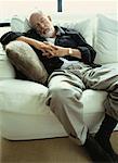 Mature Man Lying on Sofa Sleeping