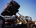 Forklift Placing Crushed Cars on Top of Stack