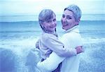 Portrait of Grandmother and Granddaughter Standing on Beach
