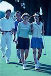 Group of People Walking on Golf Course