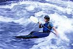 Man Kayaking in Rough Waters