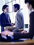 Two Businessmen Shaking Hands in Office