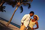 Mature Couple Standing near Palm Trees on Beach