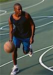 Man Dribbling Basketball Outdoors