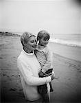 Grandmother Holding Granddaughter on Beach