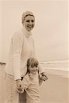 Portrait of Grandmother and Granddaughter Standing on Beach